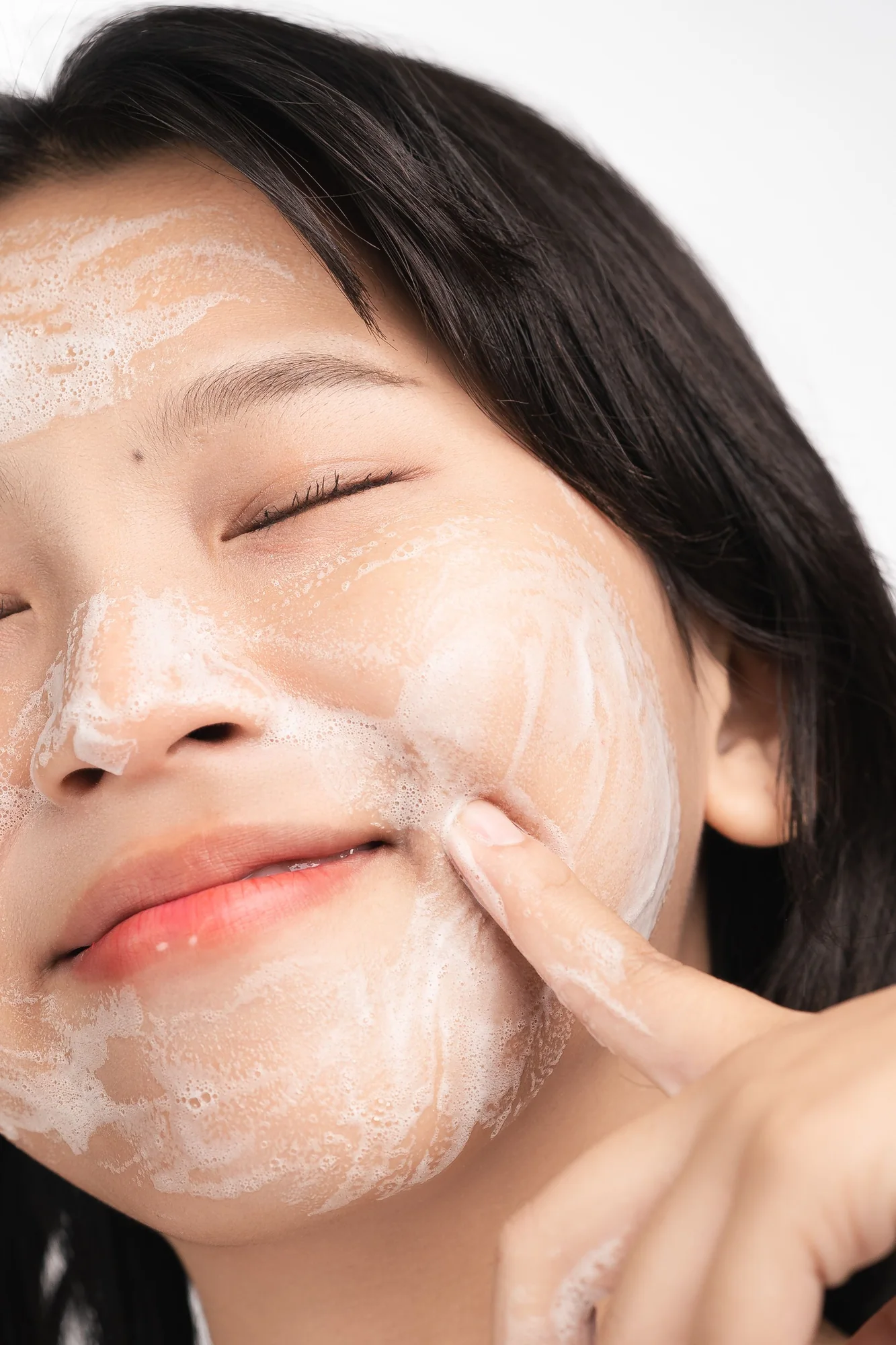 Facial cleanser being massaged into skin